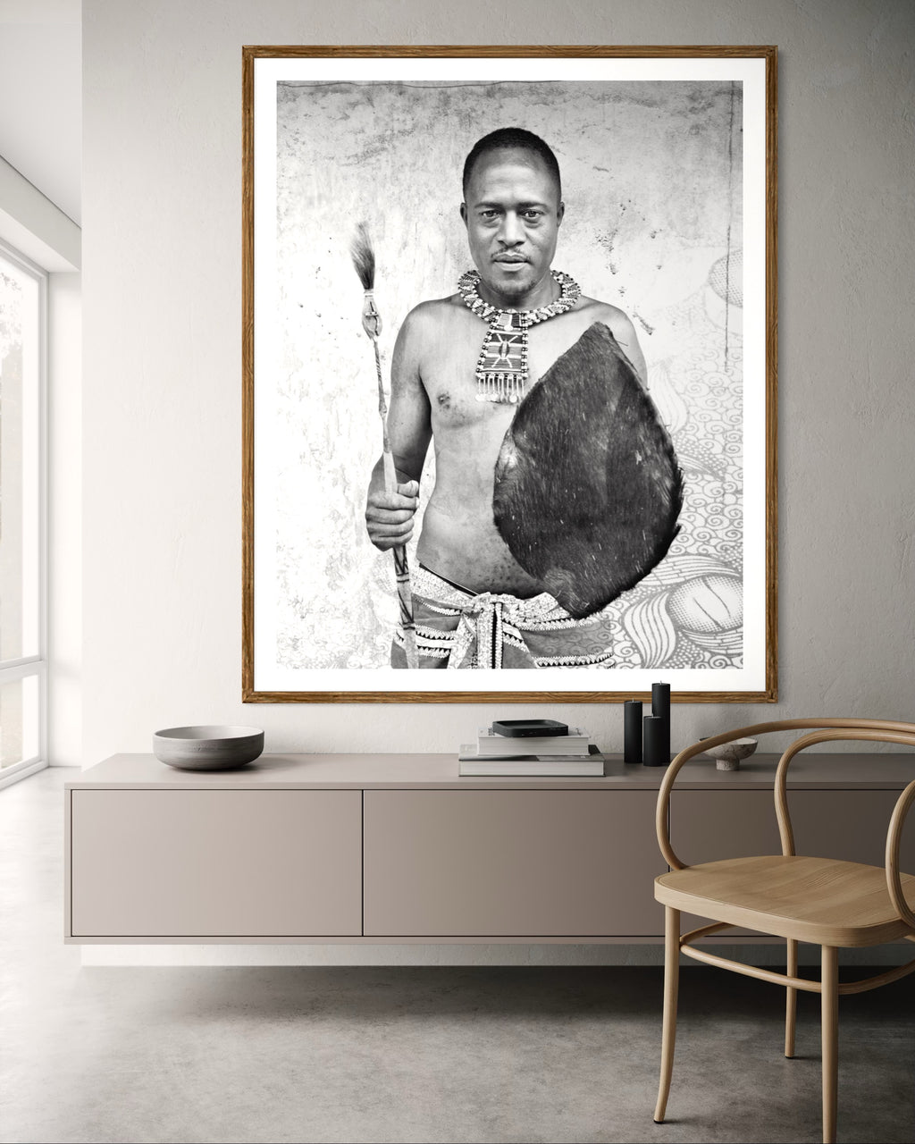 Modern interior featuring a Black and white portrait of a man holding a shield and spear against a textured wall by Francoise V Fine Art Gallery in Cape Town, South Africa
