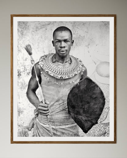 Natural Wood Kiaat framed Black and white portrait of a man holding a shield and spear against a textured wall by Francoise V Fine Art Gallery in Cape Town, South Africa